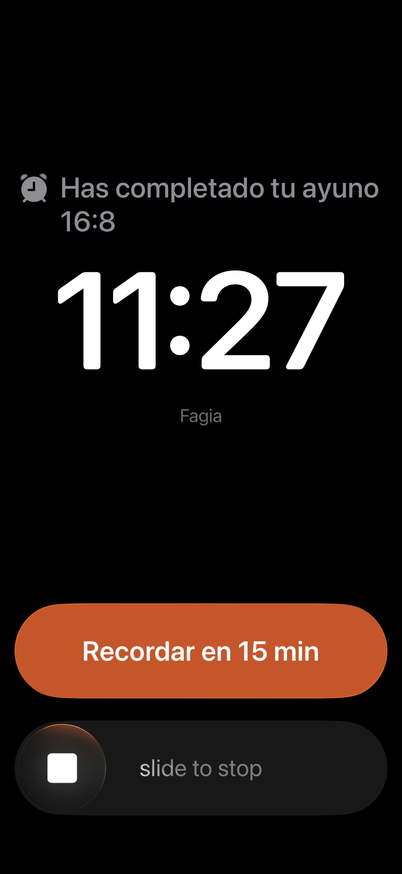 Alarma de Fagia al completar un ayuno 16:8, con opciones para recordar en 15 minutos o detener la alarma.
